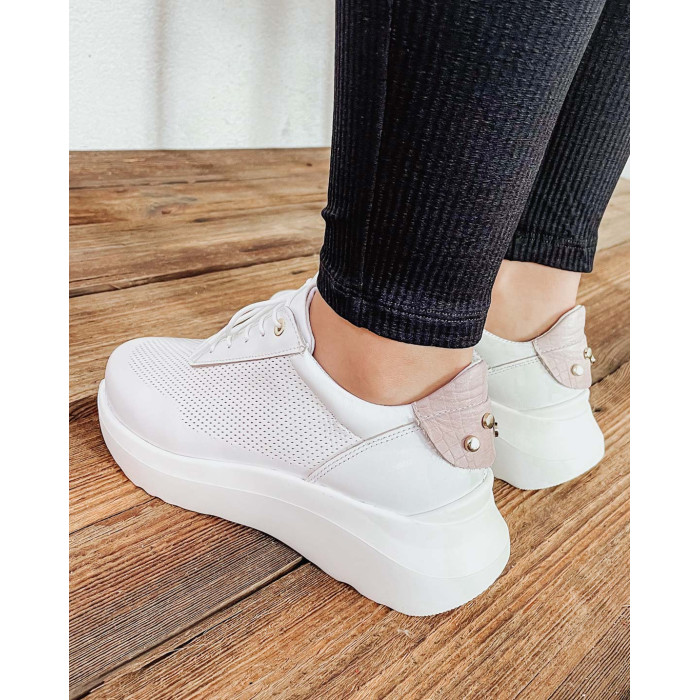 White sports shoes with openwork upper grain leather