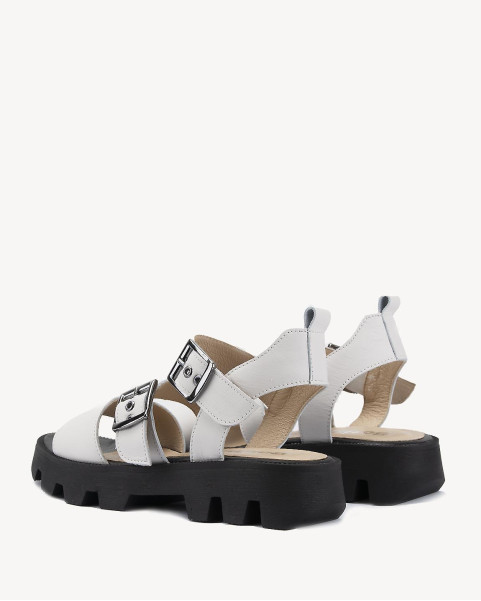 White leather sandals on a black sole