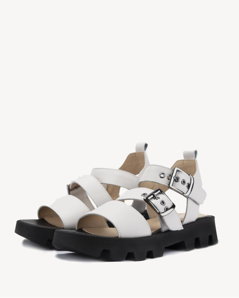 White leather sandals on a black sole