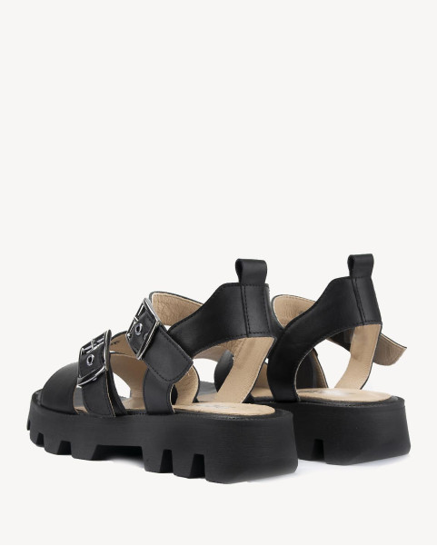 Black leather sandals on a black sole