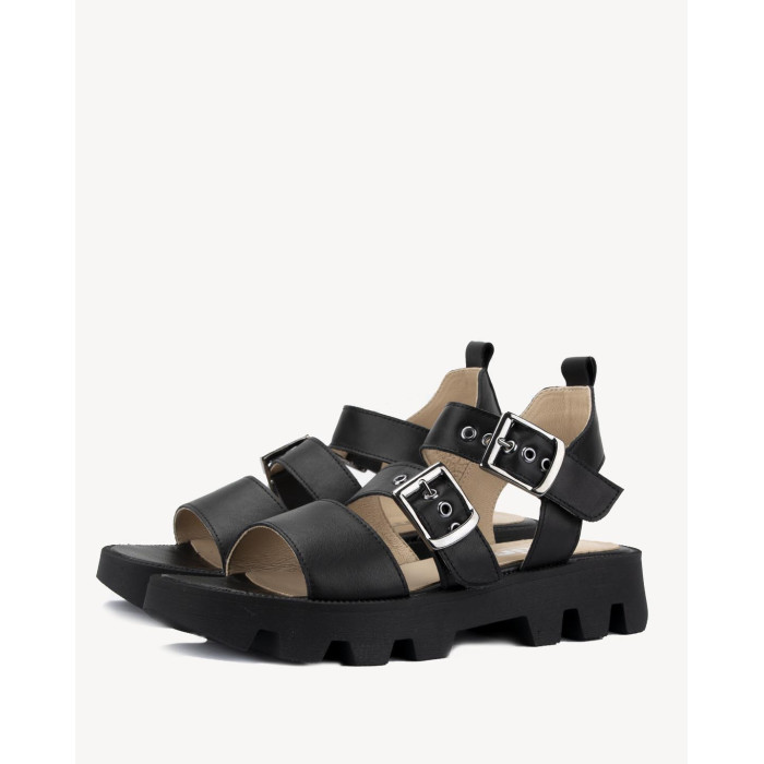 Black leather sandals on a black sole