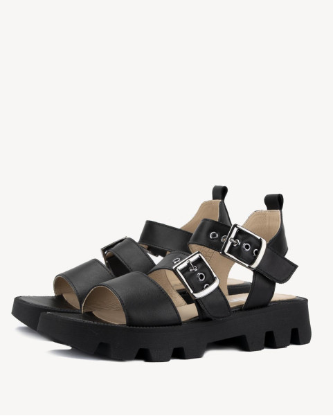 Black leather sandals on a black sole