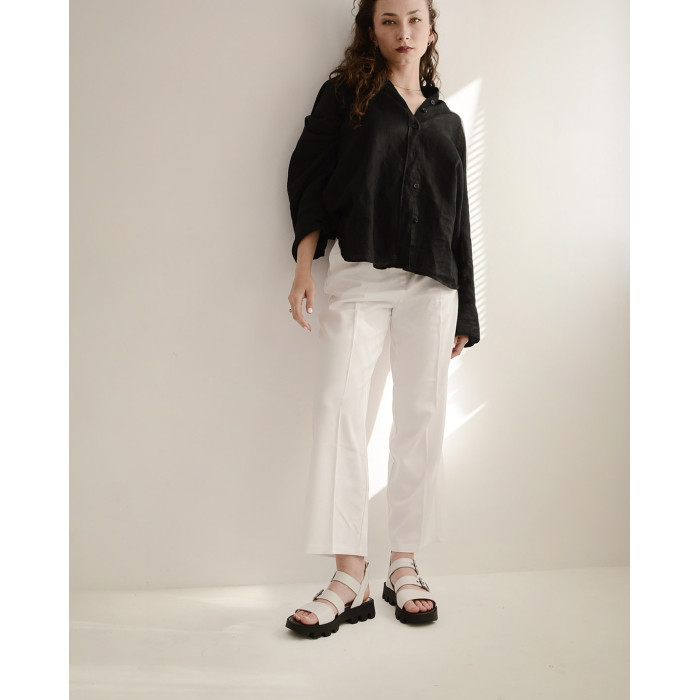 White leather sandals on a black sole