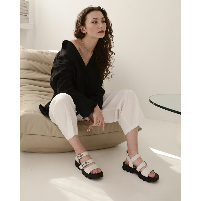 White leather sandals on a black sole
