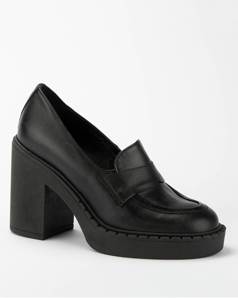 Black leather pumps on a...