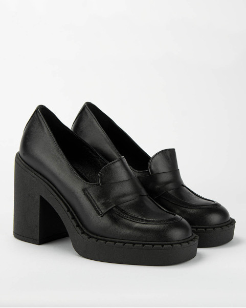 Black leather pumps on a...