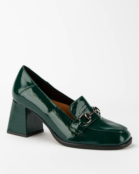 Green leather pumps on a...