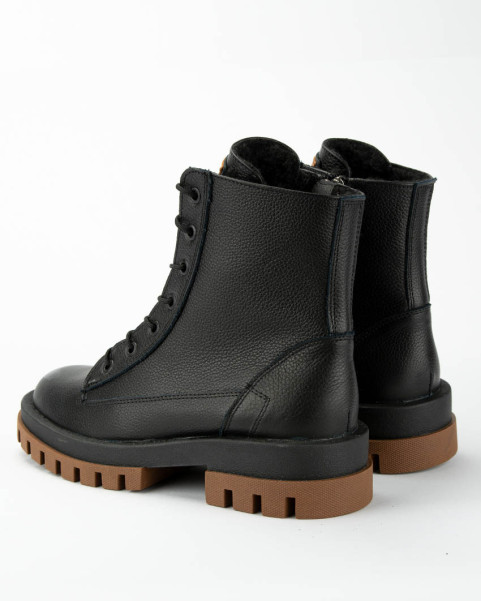 Black insulated leather boots on a platform