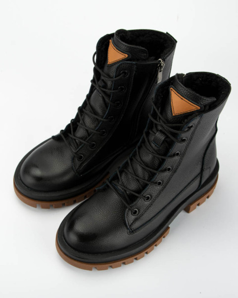 Black insulated leather boots on a platform