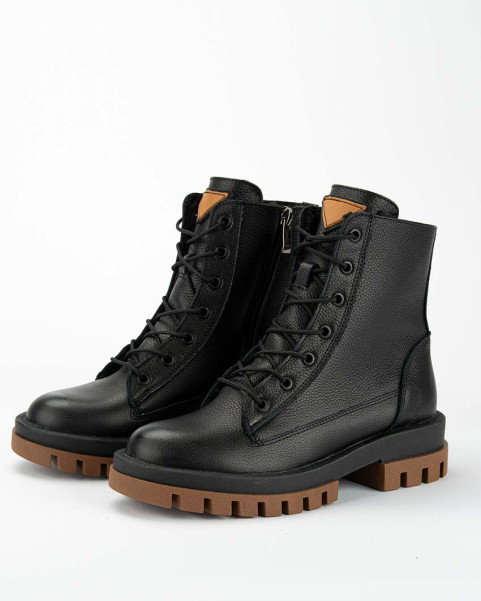 Black insulated leather boots on a platform