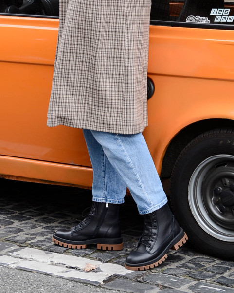 Black insulated leather boots on a platform