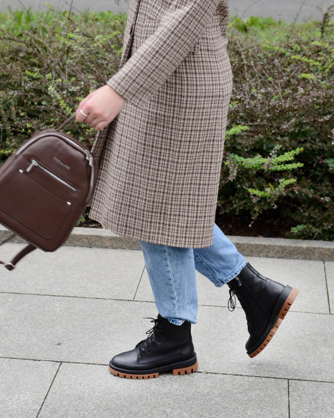 Black insulated leather boots on a platform