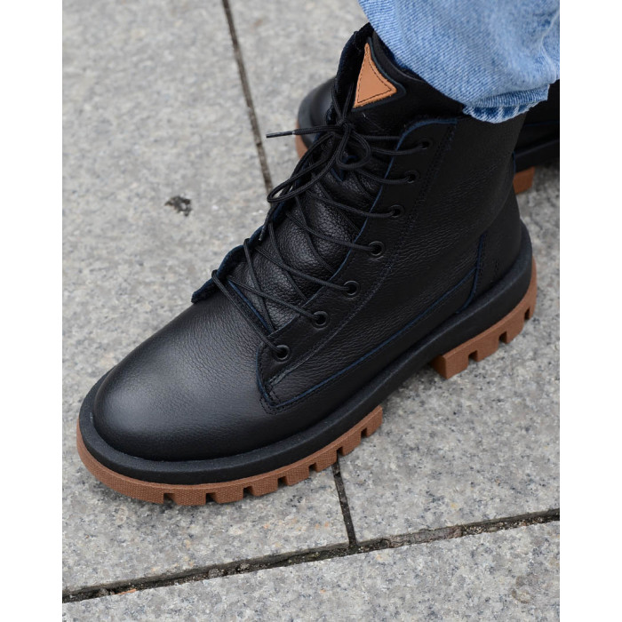 Black insulated leather boots on a platform