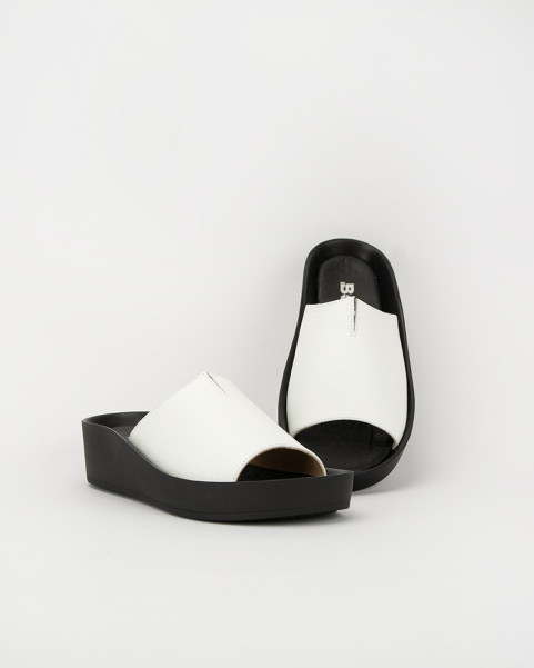 White leather flip-flops on a black sole