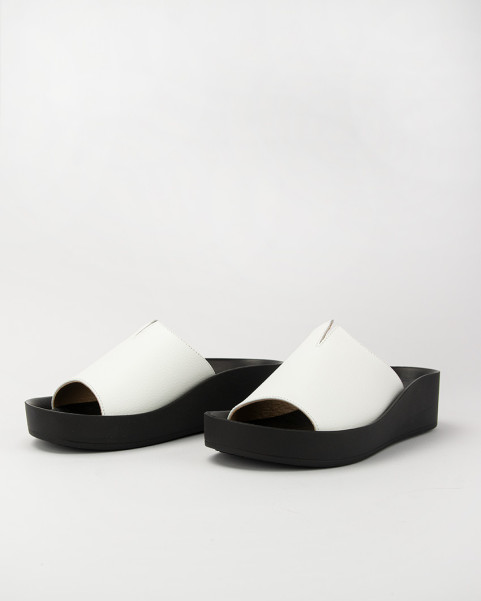 White leather flip-flops on a black sole